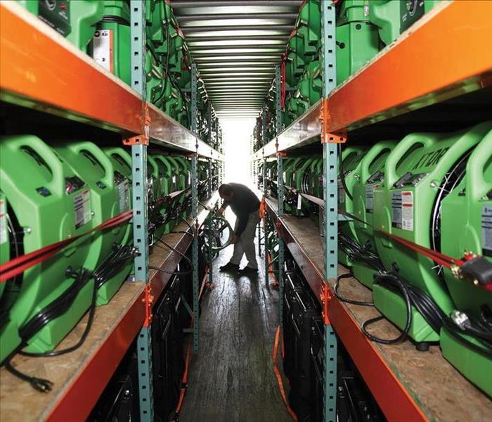 Rows of air movers in a warehouse.
