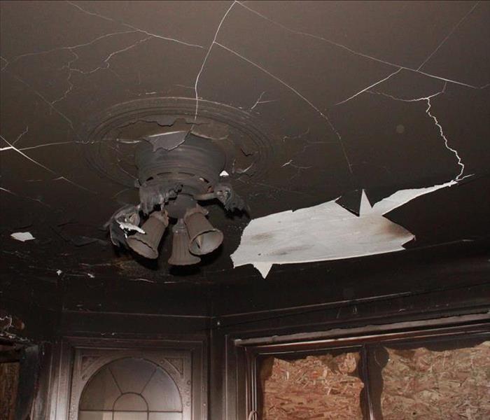 Dining room ceiling caked with fire damage.
